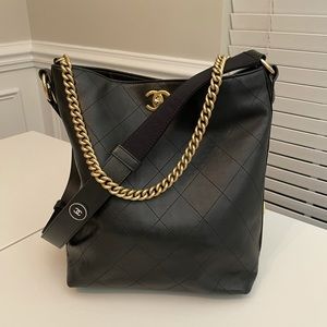 CHANEL
Black Quilted Leather Button Up Hobo Bag